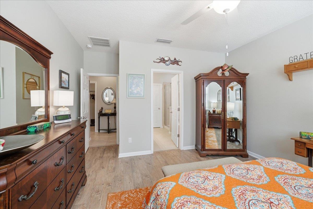 144 Litke Lane St. Augustine, FL 32086 - Photo 16 of 45 Bedroom featuring light wood finished floors, a textured ceiling, and ceiling fan