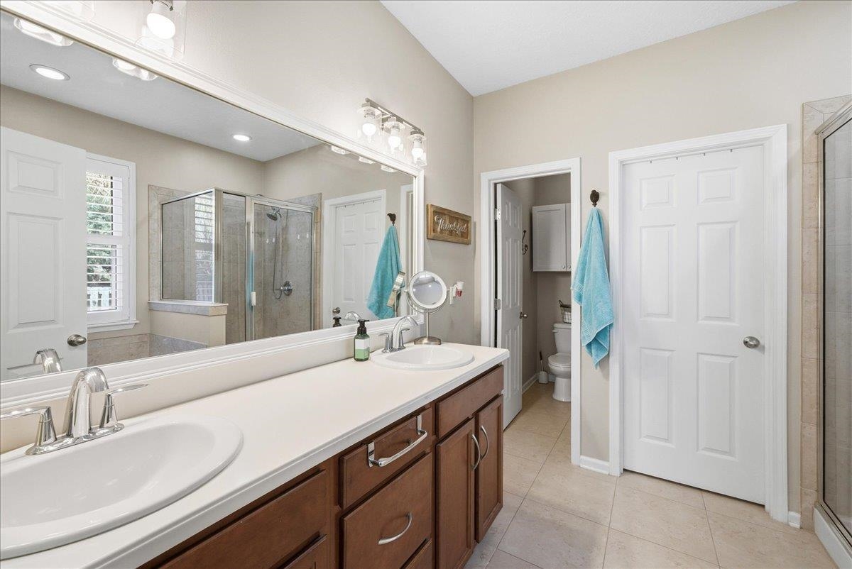 144 Litke Lane St. Augustine, FL 32086 - Photo 17 of 45 Full bath featuring double vanity, a stall shower, and light tile patterned flooring