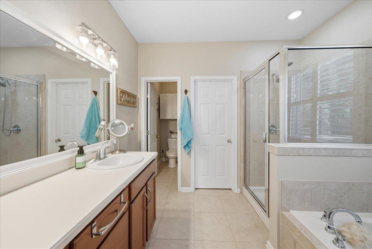 144 Litke Lane St. Augustine, FL 32086 - Photo 18 of 45 a bathroom with a double vanity sink mirror and shower