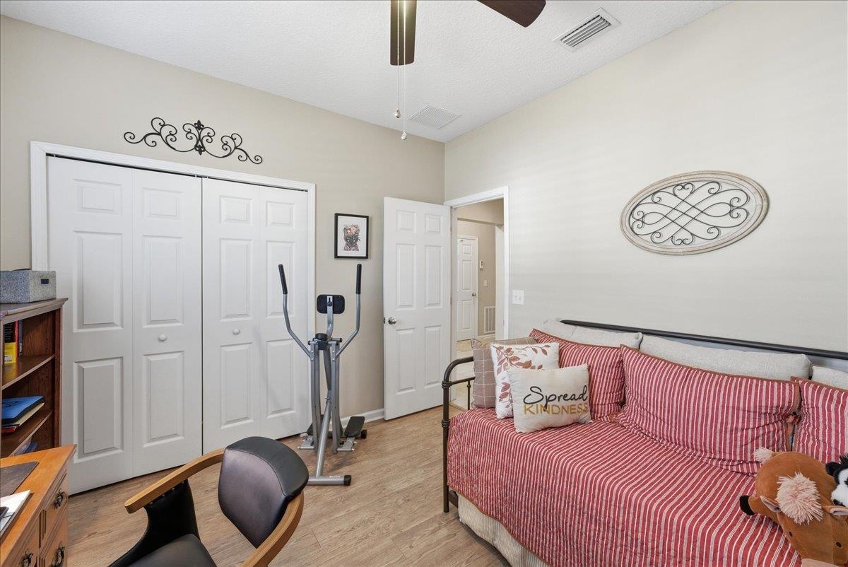 144 Litke Lane St. Augustine, FL 32086 - Photo 22 of 45 Bedroom with light wood-style floors, a closet, and a ceiling fan