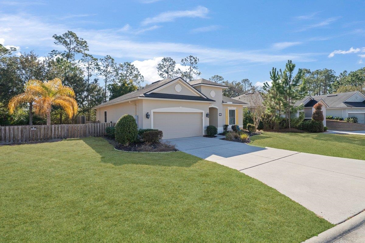 144 Litke Lane St. Augustine, FL 32086 - Photo 3 of 45 View of front of home featuring driveway, a garage, and stucco siding