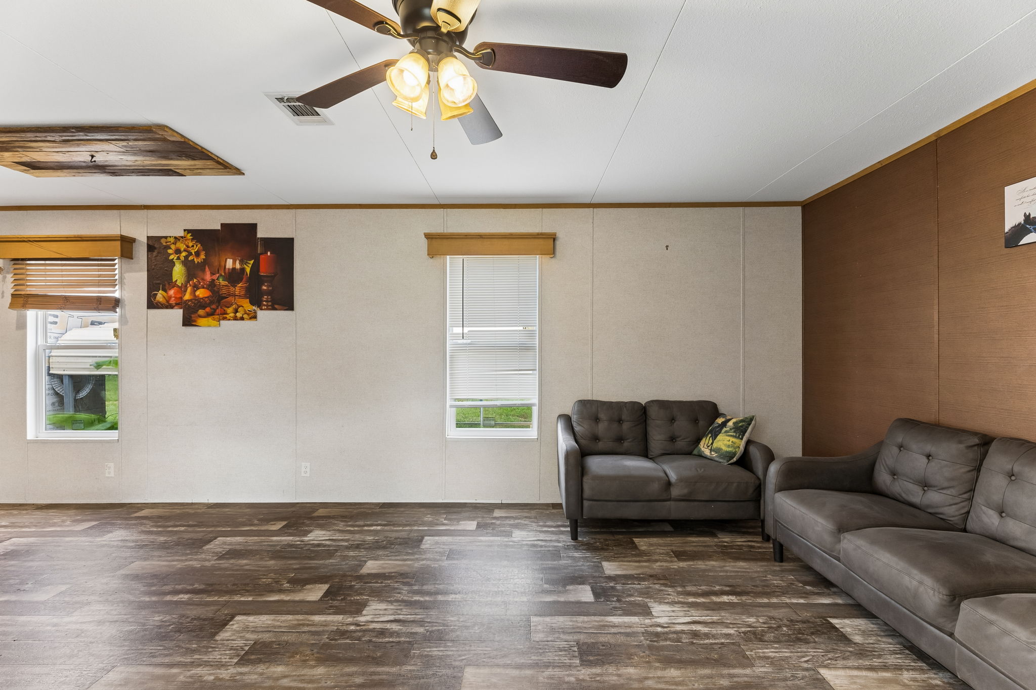 253 North County Line Road, Unit C Elgin, TX 78621 - Photo 8 of 39 Functional family room with durable flooring and a ceiling fan for comfort.