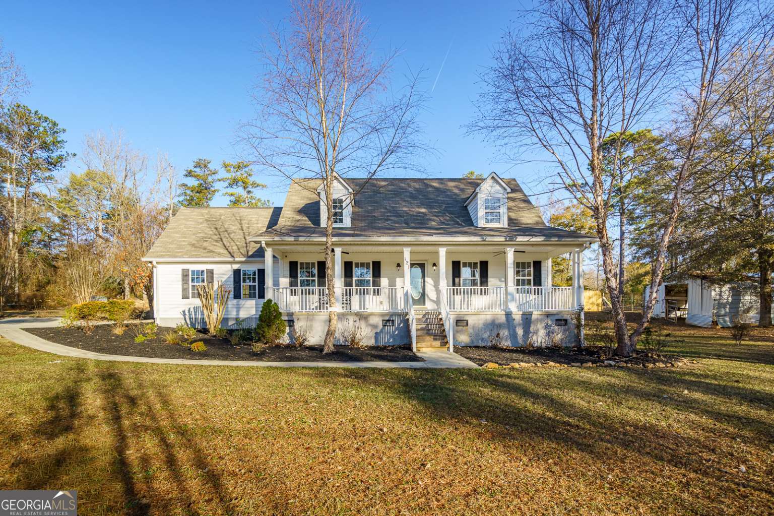 a front view of a house with a yard patio and fire pit
