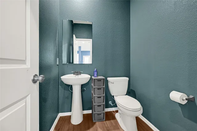 a white toilet sitting next to a bathroom sink