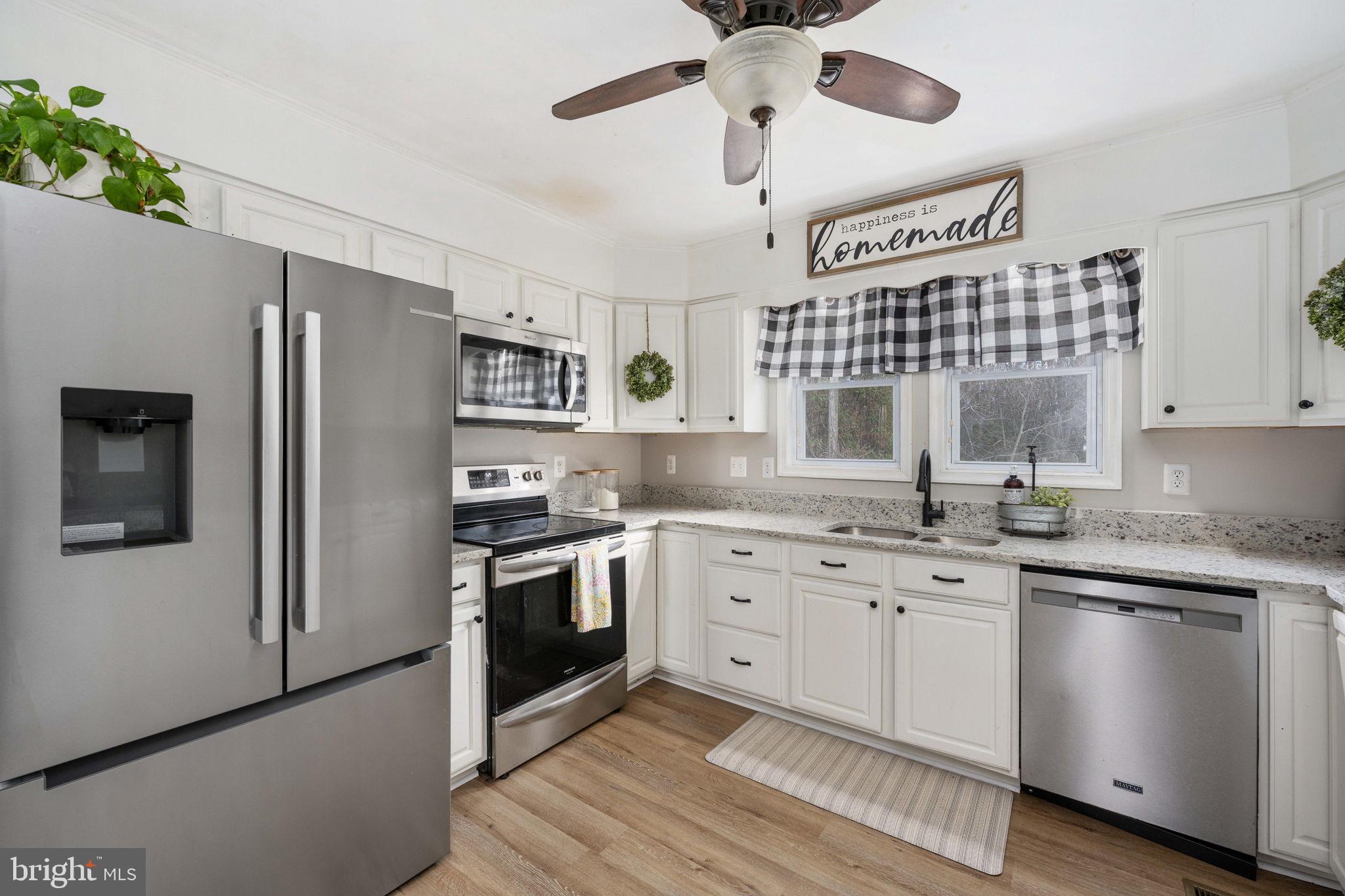 371 Greenbank Road Fredericksburg, VA 22406 - Photo 16 of 54 a kitchen with stainless steel appliances granite countertop a stove sink and refrigerator