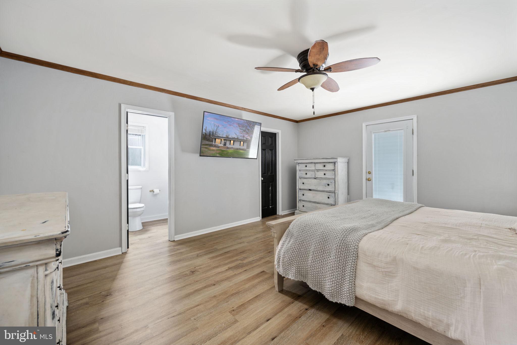 371 Greenbank Road Fredericksburg, VA 22406 - Photo 20 of 54 a bedroom with a bed and a chandelier