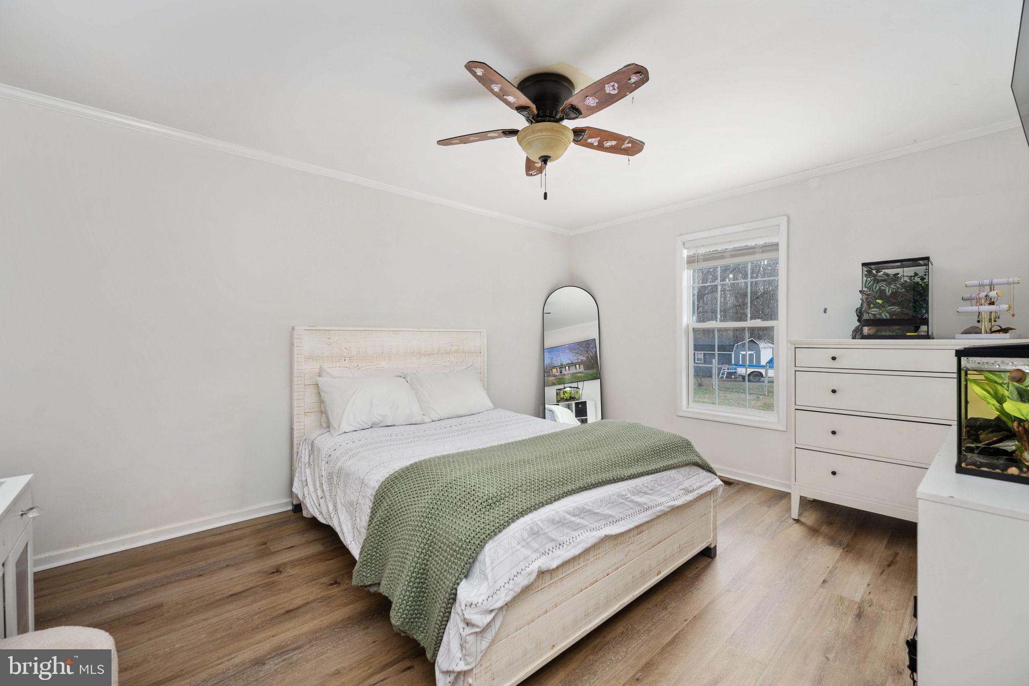 371 Greenbank Road Fredericksburg, VA 22406 - Photo 26 of 54 a bedroom with a bed and a chandelier