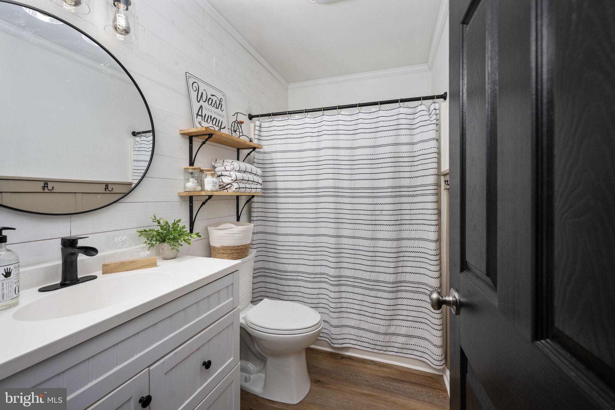 371 Greenbank Road Fredericksburg, VA 22406 - Photo 32 of 54 a bathroom with a toilet a sink and mirror