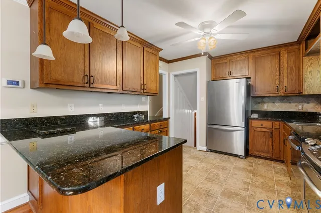 a kitchen with stainless steel appliances granite countertop a sink a stove and a refrigerator