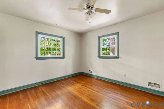 a view of room with hardwood floor and ceiling fan