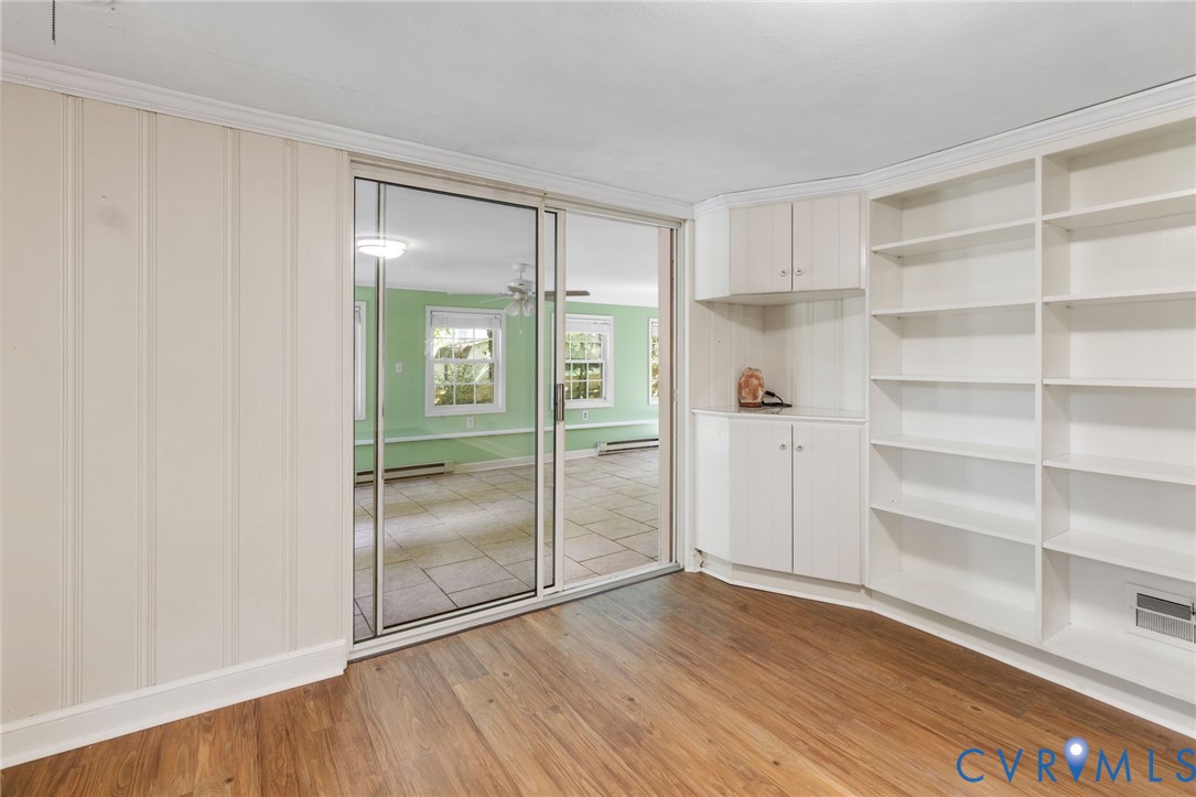 3369 Warner Road Richmond, VA 23225 - Photo 23 of 46 a view of an empty room with wooden floor and a window