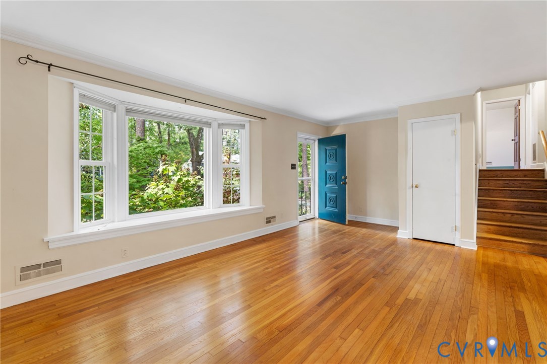 3369 Warner Road Richmond, VA 23225 - Photo 5 of 46 a view of an empty room with wooden floor and a window