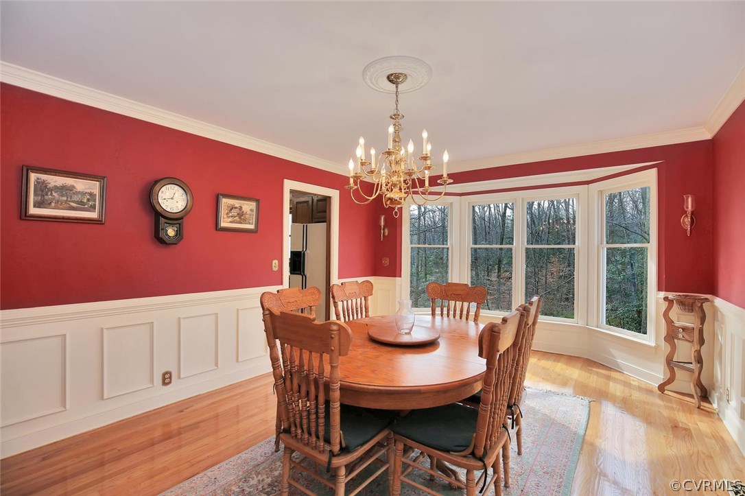 2203 Mt Blanco Road Chester, VA 23836 - Photo 4 of 27 a view of a dining room with furniture a chandelier and wooden floor