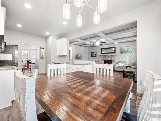 a large kitchen with a table and chairs