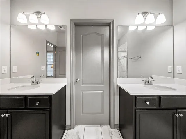 a bathroom with a sink a light fixture a vanity and a mirror