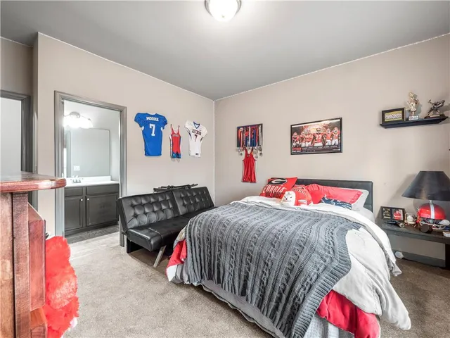 a bedroom with a bed and a couch