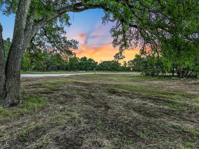 a view of outdoor space with trees all around