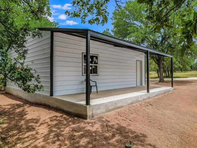 a view of a small house with garage
