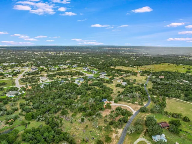 a view of a city with lush green forest