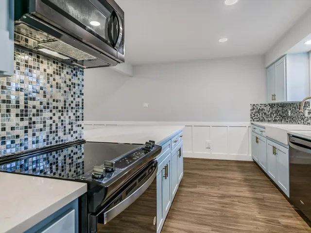 a kitchen with a stove and a refrigerator