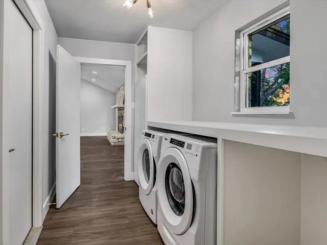 a view of a hallway with washer and dryer