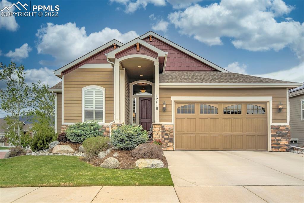 12410 Salmon Point Colorado Springs, CO 80921 - Photo 1 of 49 a front view of a house with a yard and garage