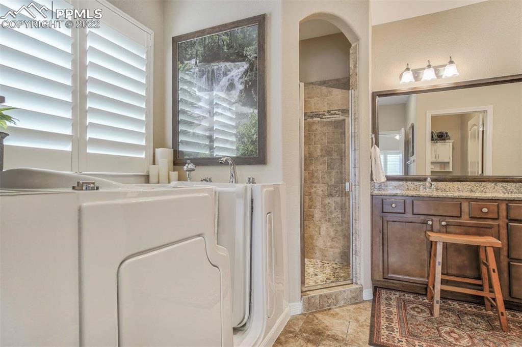 12410 Salmon Point Colorado Springs, CO 80921 - Photo 25 of 49 a bathroom with a sink and a mirror