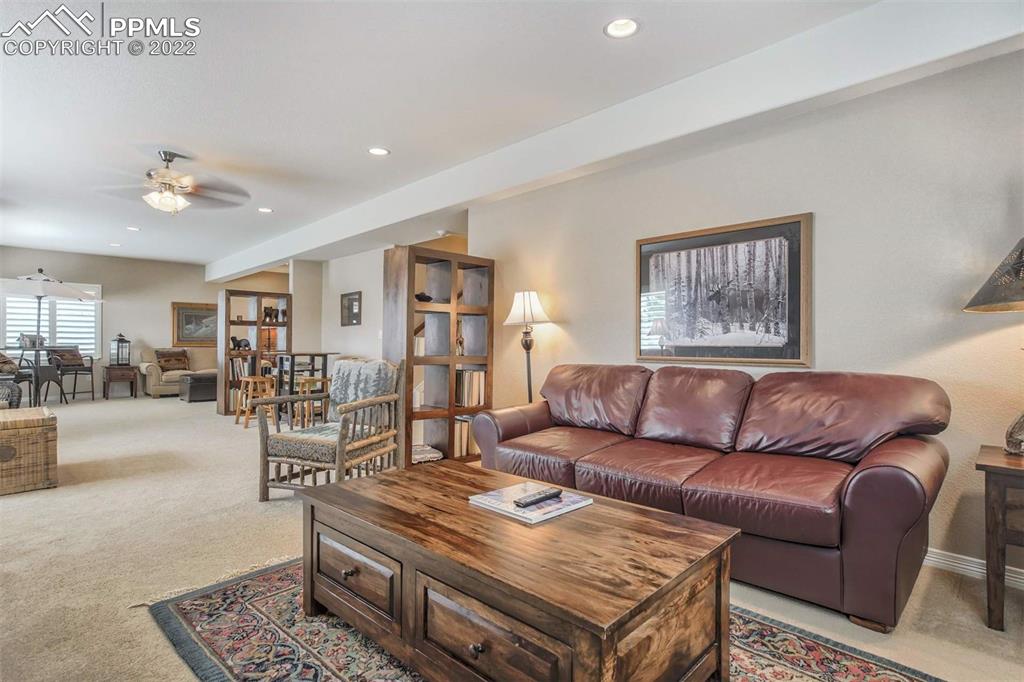 12410 Salmon Point Colorado Springs, CO 80921 - Photo 31 of 49 a living room with furniture and wooden floor