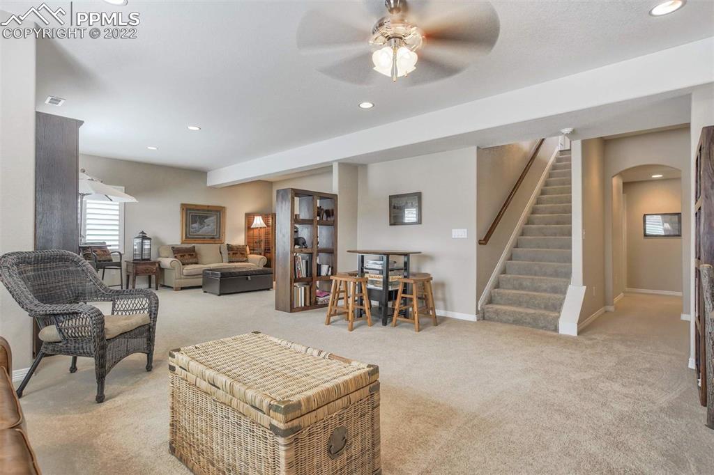 12410 Salmon Point Colorado Springs, CO 80921 - Photo 33 of 49 a living room with furniture and wooden floor