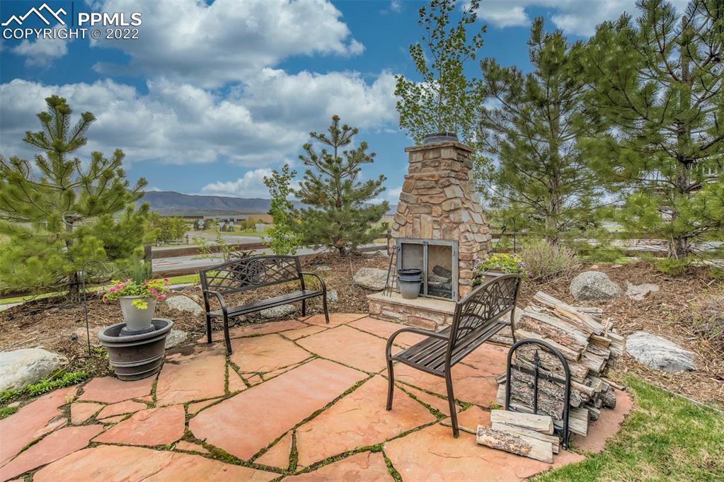 12410 Salmon Point Colorado Springs, CO 80921 - Photo 45 of 49 a view of a patio with table and chairs and potted plants