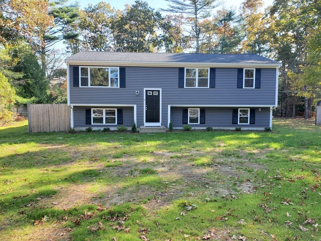 9 Rickard Street Carver, MA 02330 - Photo 1 of 26 a brick house that has a big yard with large trees
