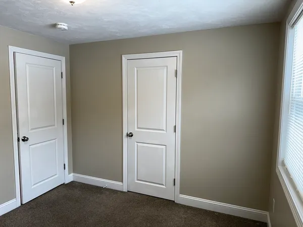 an empty room with closet area