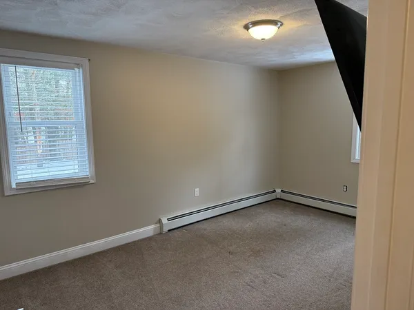 an empty room with a empty space and windows