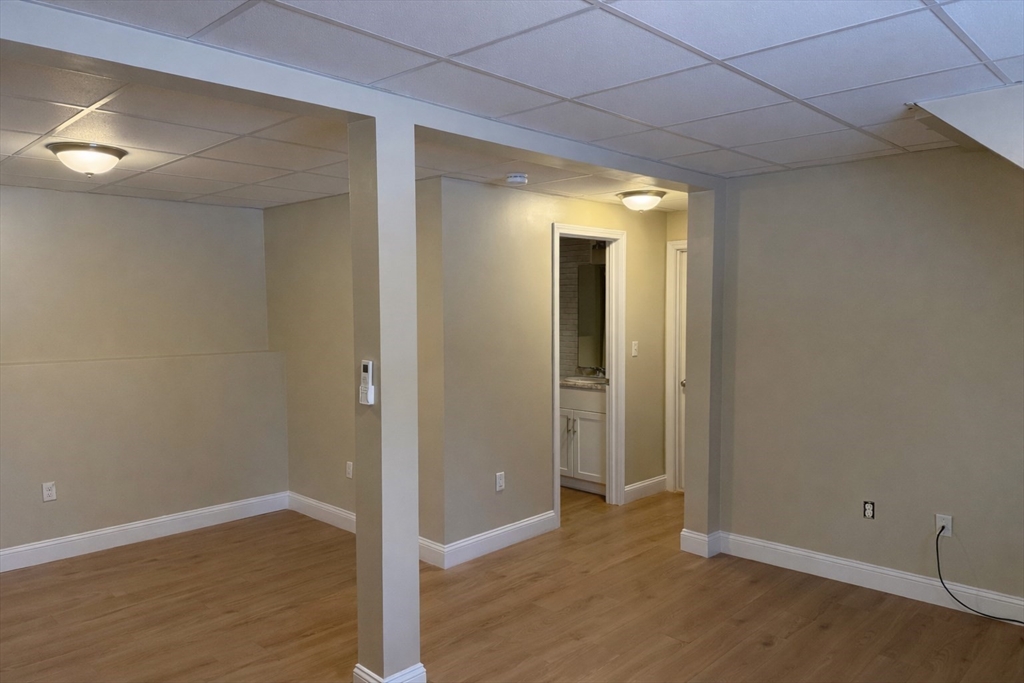 9 Rickard Street Carver, MA 02330 - Photo 21 of 26 an empty room with wooden floor and windows