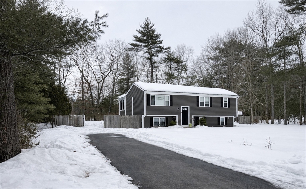 9 Rickard Street Carver, MA 02330 - Photo 22 of 26 a front view of a house with a yard covered in snow