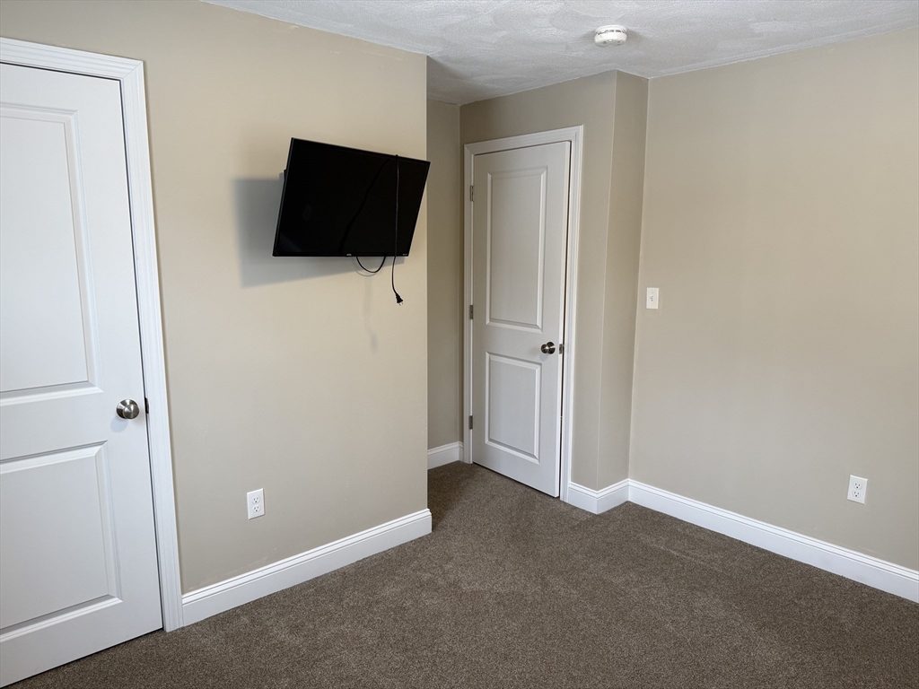 9 Rickard Street Carver, MA 02330 - Photo 24 of 26 a view of a livingroom with a flat screen tv