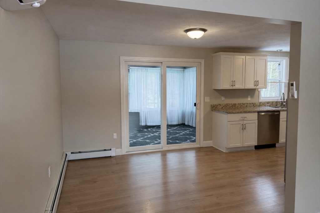 9 Rickard Street Carver, MA 02330 - Photo 5 of 26 a view of a kitchen with a sink and dishwasher white cabinets with wooden floor