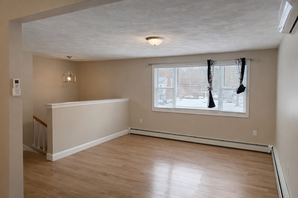 9 Rickard Street Carver, MA 02330 - Photo 8 of 26 a view of an empty room with wooden floor and a window