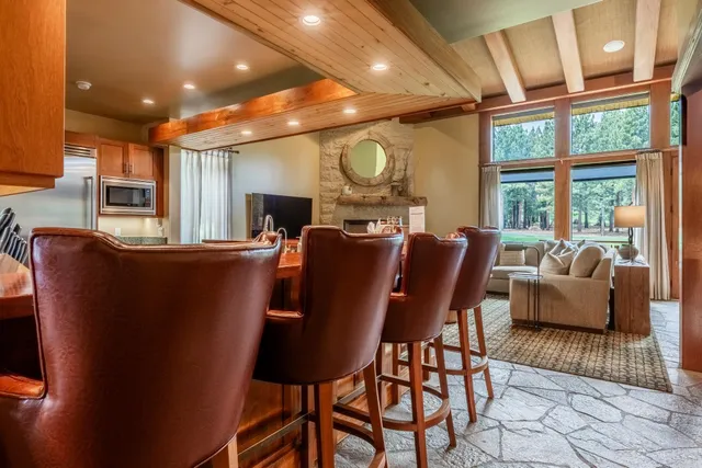 a dining room with furniture and a large window