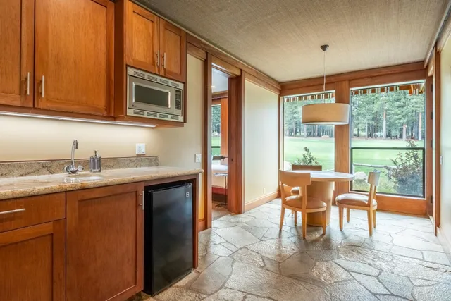 a bedroom with furniture and a large window