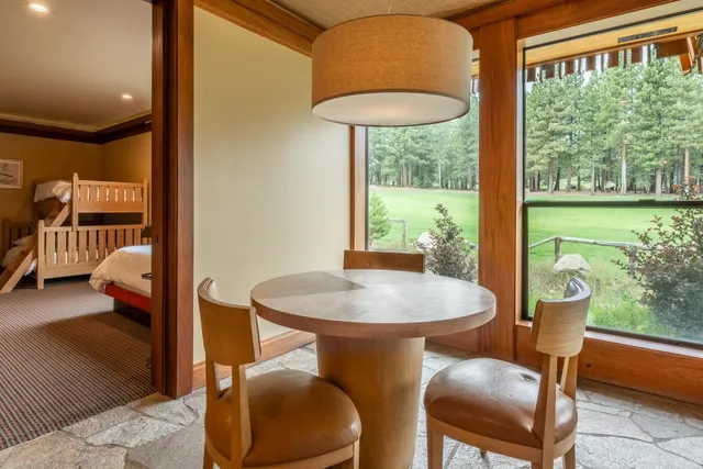 a open kitchen with a sink dining table and chairs