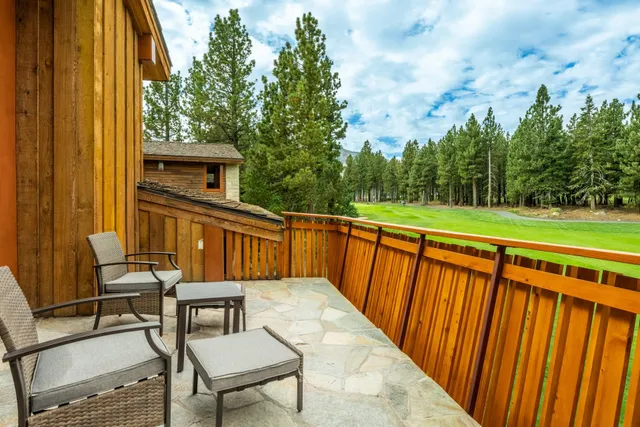 a balcony with a table and chairs