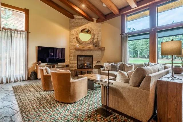 a living room with furniture a fireplace and a flat screen tv