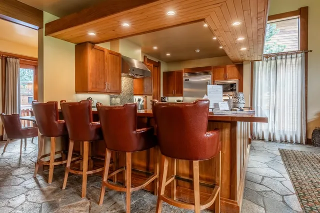 a dining room with furniture and a large window