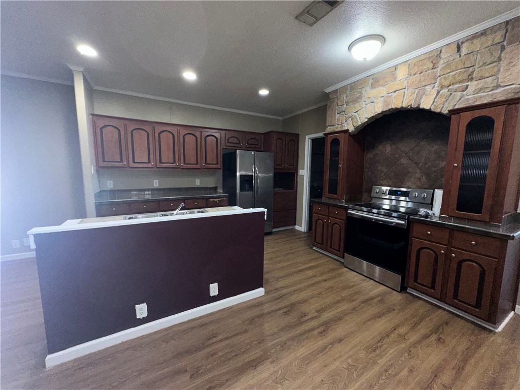 Undisclosed Address Robstown, TX 78380 - Photo 4 of 17 a kitchen with stainless steel appliances granite countertop a stove a sink and a microwave