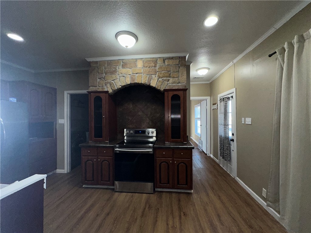 Undisclosed Address Robstown, TX 78380 - Photo 5 of 17 a kitchen with kitchen island stainless steel appliances a sink stove refrigerator and cabinets