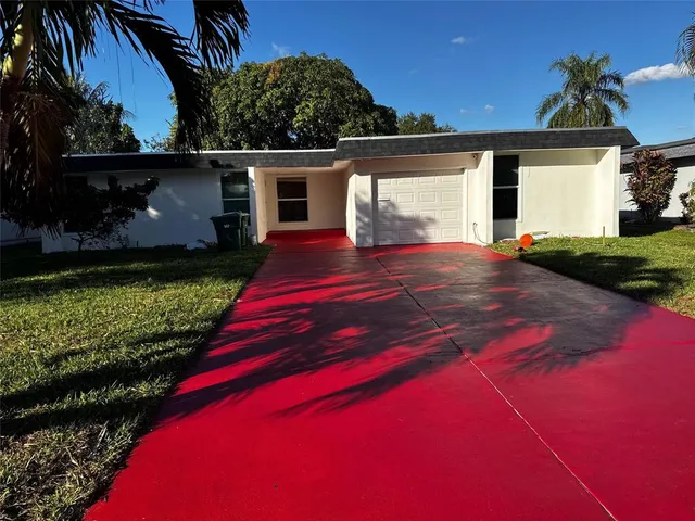 a view of backyard of house with green space
