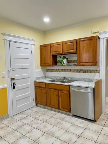 a kitchen with stainless steel appliances granite countertop a sink and a stove top oven