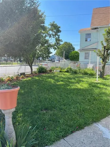 a view of a backyard with plants and a garden