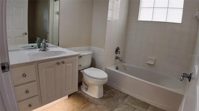 a bathroom with a sink toilet vanity and tub